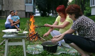 The habitants of one of houses Kalita village make dinner on a fire