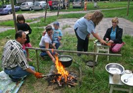 The habitants of one of houses Kalita village make dinner on a fire