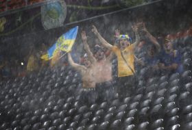 Fans of the team of Ukraine during a thundershower