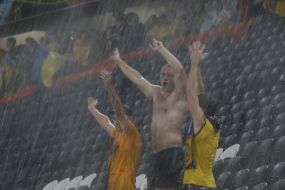Fans of the team of Ukraine during a thundershower