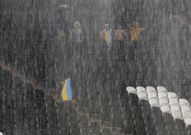 Fans of the team of Ukraine during a thundershower