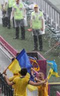 Fans of the team of Ukraine during a thundershower