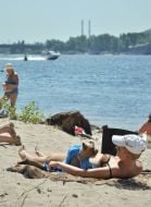 Girl with a dog on a beach in Kiev