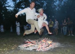 Young people jump through a fire 