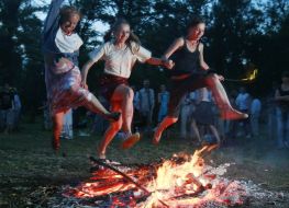 Young people jump through a fire 
