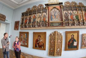 Visitors examine icons