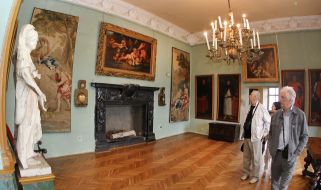 Visitors examine pictures