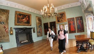 Visitors examine pictures 