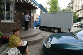 A woman sits near Lukyanovka pre-trial prison