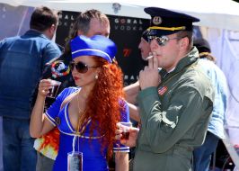 The girl in the form of flight attendants and pilots dressed in biker