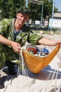 Participant of military exercises collects the parachute