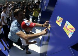 A man with child sticks a sticker