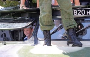 The boy at the exhibition of military equipment