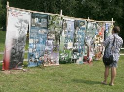 Participants of the festival considers the poster