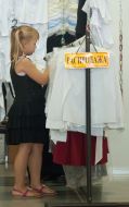 A schoolgirl chooses a blouse