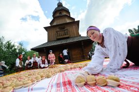 A woman picks apples