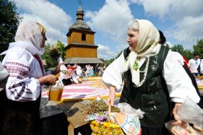 A woman holds a basket with fruit