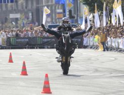 Young man executes a trick on the motor cycle 