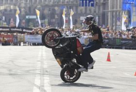 Young man executes a trick on the motor cycle 