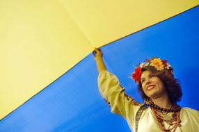A girl standing under the flag