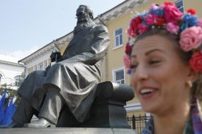 A girl near the monument to Michael Grushevskij