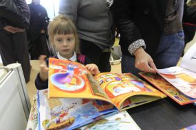 A girl examines a book