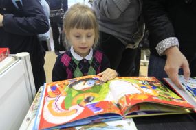 A girl examines a book