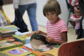 A girl examines a book