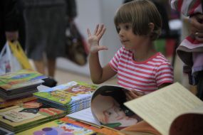 A girl examines a book