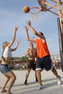 Competitors play basketball