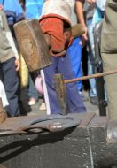 The blacksmith does a horseshoe