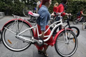 A girl carries a bicycle