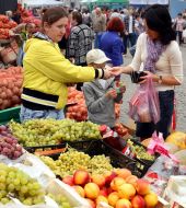 A woman buys fruit