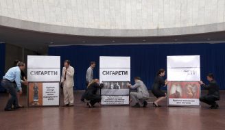 Protestors sets a pack of cigarettes