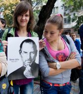 A girl hold a poster of Steve Jobs