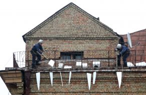 Community services workers on the roof