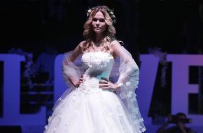 Model demonstrates a wedding dress