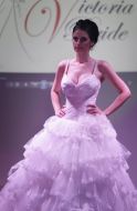 Model demonstrates a wedding dress