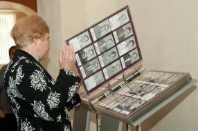 A visitor views an album with photos