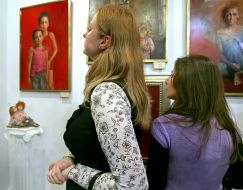 Visitors of the exhibition considers painting