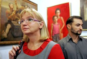 Visitors of the exhibition considers painting