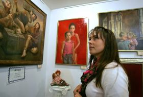 Visitors to the exhibition considers painting 