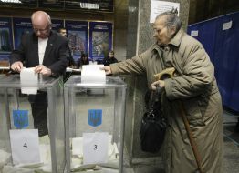 Избиратели бросают бюллетени для голосования в урну