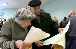 Літні люди розглядають бюлетені