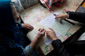 Пожилая женщина голосует дома