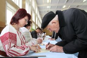 The elderly man gets a voting paper