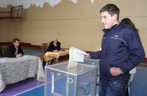 Voter cast ballots in the ballot box