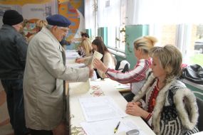 The elderly man gets a voting paper