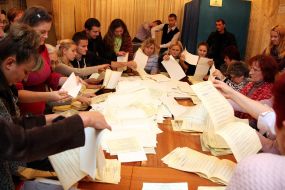 Members of the election commission consider ballots