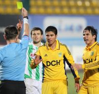 A referee shows a yellow card